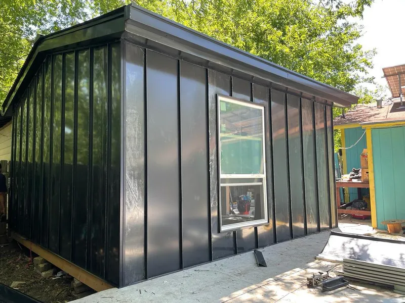 Black standing seam metal wall panels for Roof Inspection in Deer Park